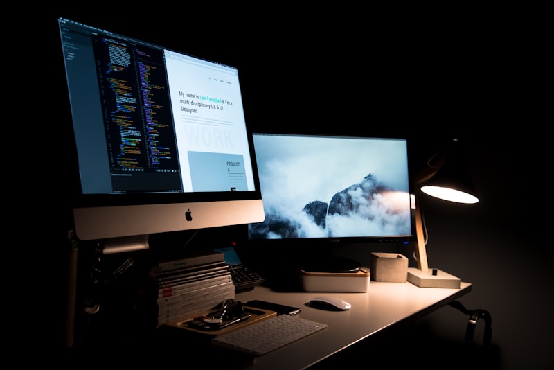 Developer workspace with laptop and analytics dashboard on screen